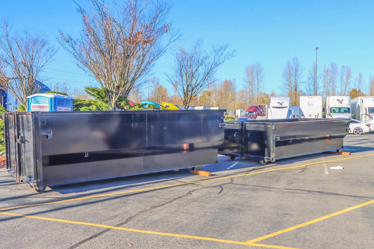Professional dumpster rental service with roll-off container on residential driveway in State College